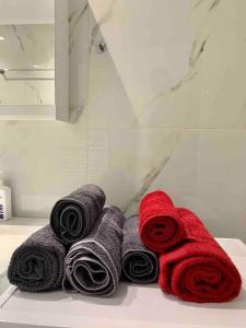 a pile of towels sitting on a counter in a bathroom at Luxury spacious apartment in the heart of the city in Rhodes Town