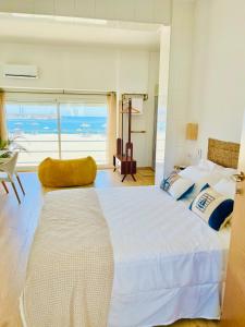 a bedroom with a large bed with a view of the ocean at Hostal playa Dreams náutico in Garrucha