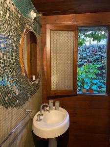 a bathroom with a sink and a window at Casa Almendra in Rosario