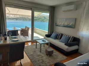 a living room with a couch and a table at Apartments Bouvier in Pag