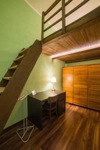 an office with a desk and a loft bed at Apartmán u Bretschneidera in Banská Štiavnica