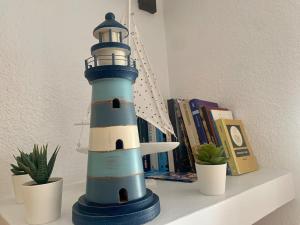 a blue and white lighthouse lamp sitting on a shelf at Calella centro in Calella de Palafrugell