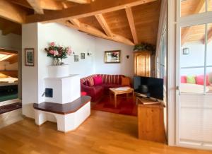a living room with a couch and a tv at Landhaus Elisabeth in Sankt Johann im Pongau