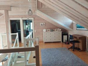 a attic room with a staircase and a desk at Villa Mustalahti in Mikkeli