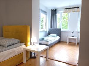 a living room with a bed and a couch at Sopot Rooms in Sopot