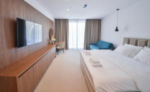 a hotel room with a bed and a flat screen tv at Hotel Riva in Budva +35 photos