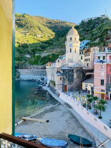 a view from a window of a town with a clock tower at La Marina Vernazza Appartamento Piazza Marconi in Vernazza