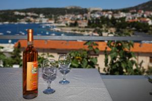 a bottle of wine and two wine glasses on a table at SeaView Guesthouse in Hvar