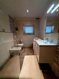 a bathroom with a sink and a toilet and a tub at ForRest Apartment in Portorož