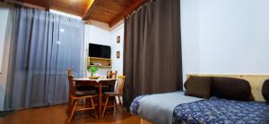 a bedroom with a bed and a table and a chair at Apartments Ritoša in Izola