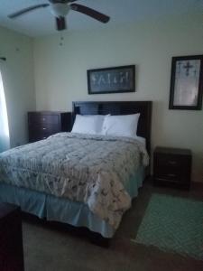 a bedroom with a bed and a ceiling fan at Rio View Apartments in Ocho Rios