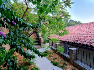 a house with a red roof and a garden at ForRest Apartment in Portorož
