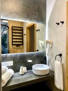 a bathroom with a sink and a mirror at REMAR - Apartamenty z widokiem na Jezioro Biale in Augustów