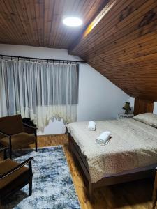 ein Schlafzimmer mit einem Bett, einem Stuhl und einem Fenster in der Unterkunft Apartman Alex 7 in Bajina Bašta