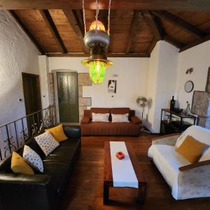 a living room with a couch and a table at Melina Heritage House in Cres