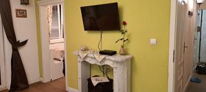 a room with a table with a tv on a wall at 2 Rooms Apartment in old Town in Košice