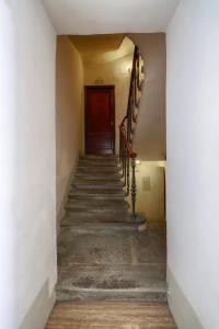 an empty hallway with stairs and a wooden door at HT Residence Maximus in Rome