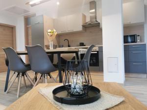 a kitchen and dining room with a table and chairs at Apartma Bella Nadiža in Kobarid