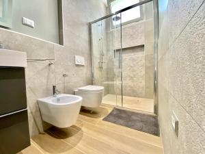 a bathroom with a toilet and a glass shower at Casa Mora in San Vero Milis +27 photos