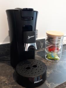 a black coffee maker sitting on a counter at "Au pied du Beffroi" - Superbe emplacement in Arras