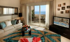 a living room with a couch and a table at Azzurra Sahl Hasheesh in Hurghada