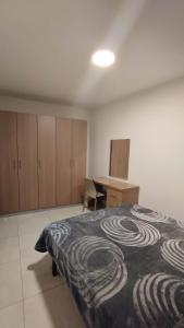 a bedroom with a bed and a desk in it at Private Room in a Big aparment in Msida