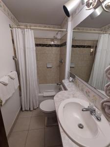 a bathroom with a sink and a toilet and a tub at Bennington Motor Inn in Bennington