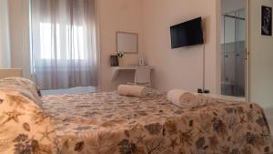 a bedroom with a bed with two pillows on it at B&B Art in Reggio Calabria