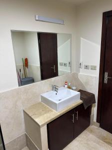 a bathroom with a sink and a mirror at Azzurra Sahl Hasheesh in Hurghada