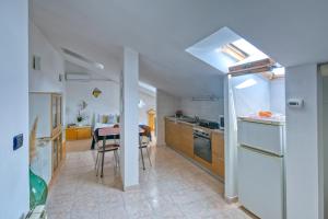 a kitchen with a white refrigerator and a table at Loft Superga on green river Po' Torino in San Mauro Torinese