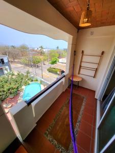 a room with a balcony with a view of a street at Casa Puerto Bonito & Private Coworking in Puerto Escondido