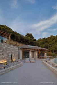 a stone house with a patio and a pool at Villa Vrachos luxury Living in Vrachos