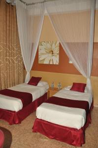 Postel nebo postele na pokoji v ubytování Eureka Place Hotel Kampala