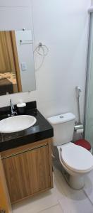 a bathroom with a white toilet and a sink at Confort Lencois Preguicas in Barreirinhas