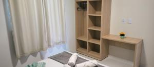 a bedroom with a bed and a book shelf at Confort Lencois Preguicas in Barreirinhas