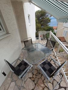 a table and two chairs on a patio at DIN2 Ljubic in Mimice