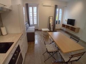 een keuken en een woonkamer met een tafel en een bank bij 11 rue Vauban in Antibes
