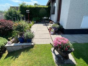 a garden with potted plants and a patio at Hillside View, Inverness in Inverness