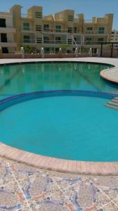 a large swimming pool in front of a building at Aida in El Alamein