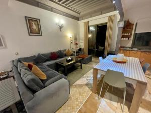 a living room with a couch and a table at Au Cœur de la Palmeraie de Marrakech in Marrakech