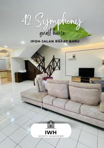 a living room with a couch and a tv at Ipoh 42 Symphony 12pax 4Bedroom 3bathroom 3carpark in Ipoh