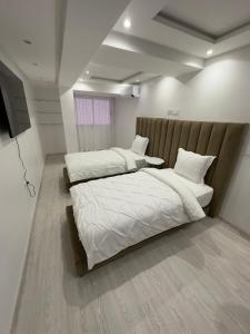 Duas camas individuais num quarto com ainil em Super appartement moderne neuf em Marrakech