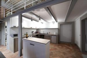 a large kitchen with a counter in a room at La Casetta in Tarquinia
