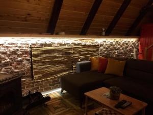 a living room with a couch and a brick wall at Tenora in Rize