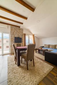 a living room with a table and chairs and a couch at Apartments Andrea in Kotor