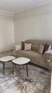 sala de estar con sofá y 2 mesas en Oak Nest 306 en Kericho