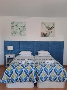 two beds sitting next to each other in a bedroom at Lovely new House - Guests Apartments in Olhão
