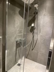 a shower with a glass door in a bathroom at Ladadika Deluxe Studio in Thessaloniki