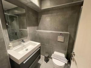 a small bathroom with a sink and a toilet at Ladadika Deluxe Studio in Thessaloniki