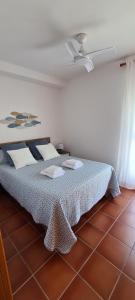 a bedroom with a bed with a brown tile floor at Siente el relax. in Alcossebre +21 photos